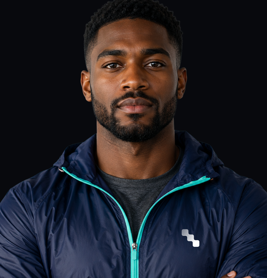 Front-facing bearded man in a navy hooded jacket with turquoise trim against a black background.